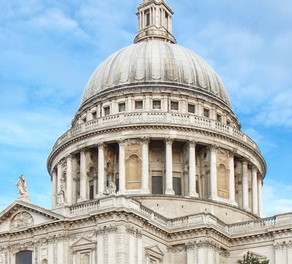 St Paul's Cathedral dome in London against a blue sky.