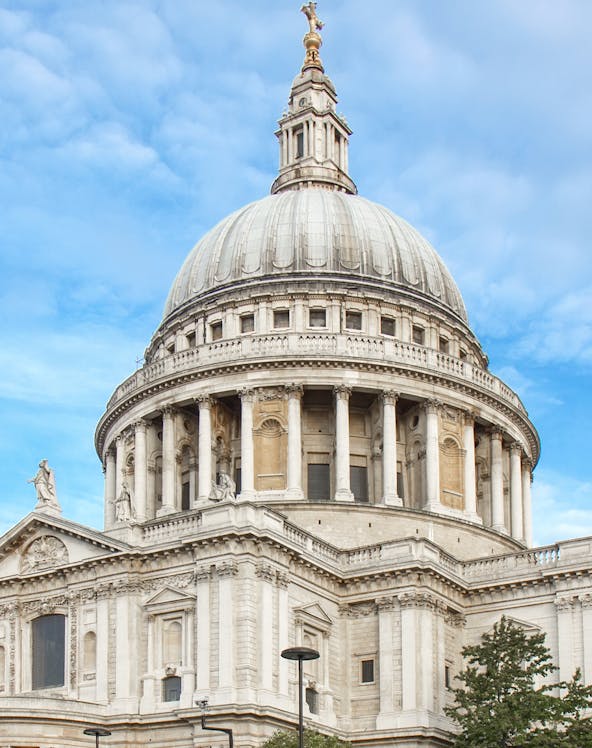 St Paul's Cathedral dome in London against a blue sky.