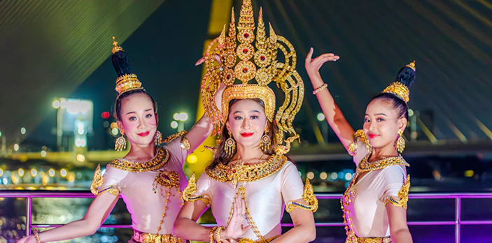 Performers in traditional attire on Bangkok Chao Phraya dinner cruise.