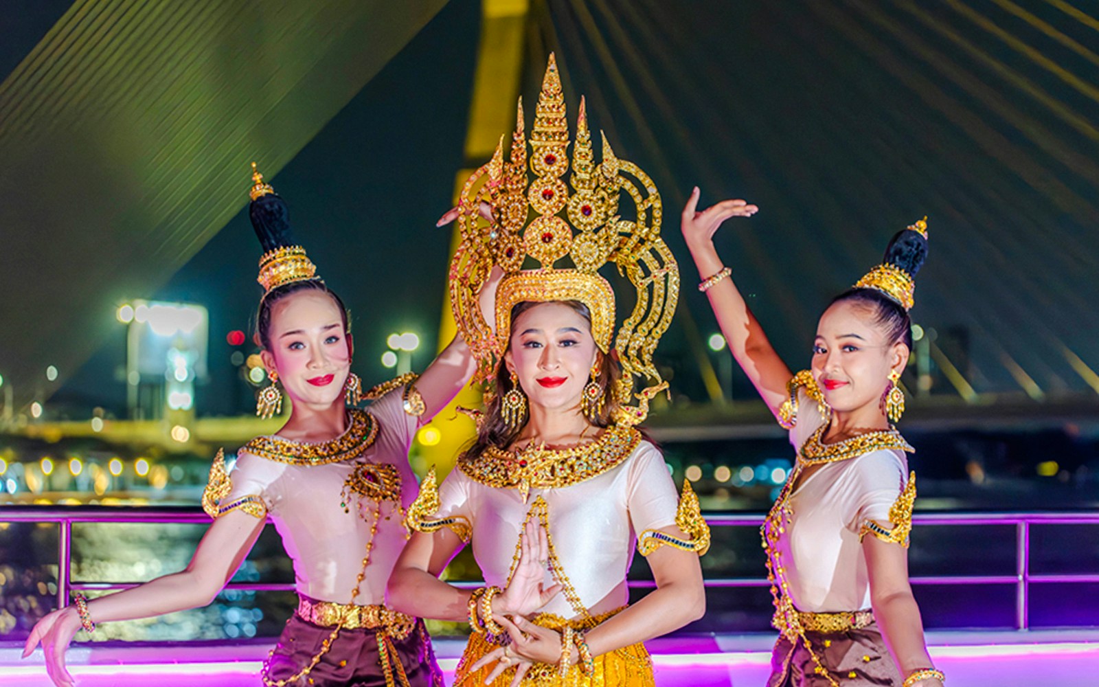 Performers in traditional attire on Bangkok Chao Phraya dinner cruise.
