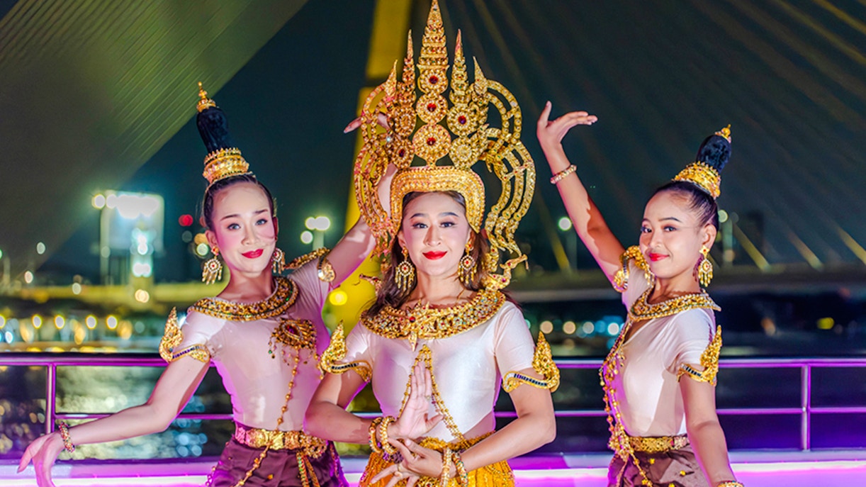 Performers in traditional attire on Bangkok Chao Phraya dinner cruise.