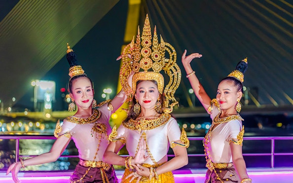 Performers in traditional attire on Bangkok Chao Phraya dinner cruise.