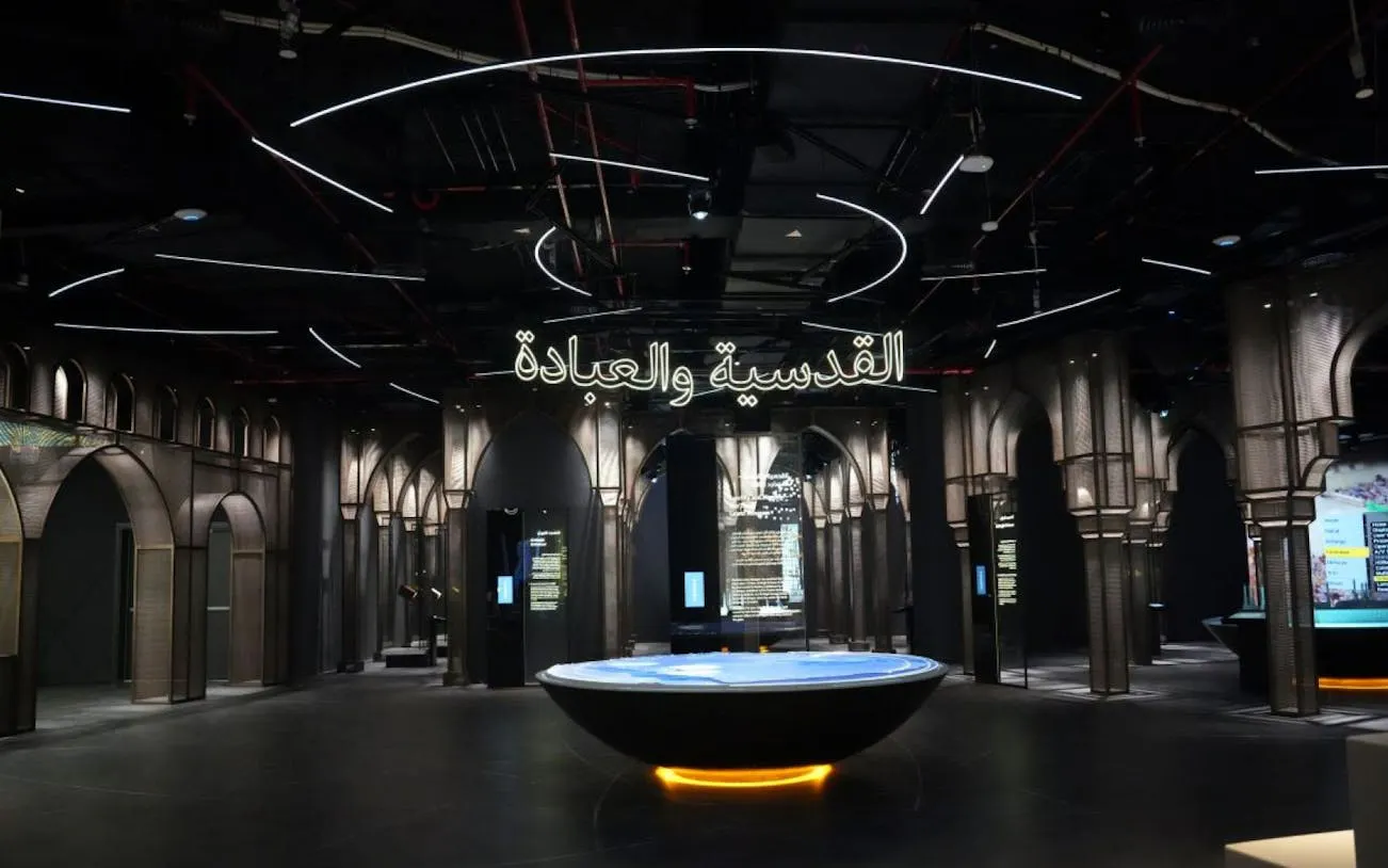 Light & Peace Museum interior at Sheikh Zayed Grand Mosque Centre, featuring illuminated arches and exhibits.