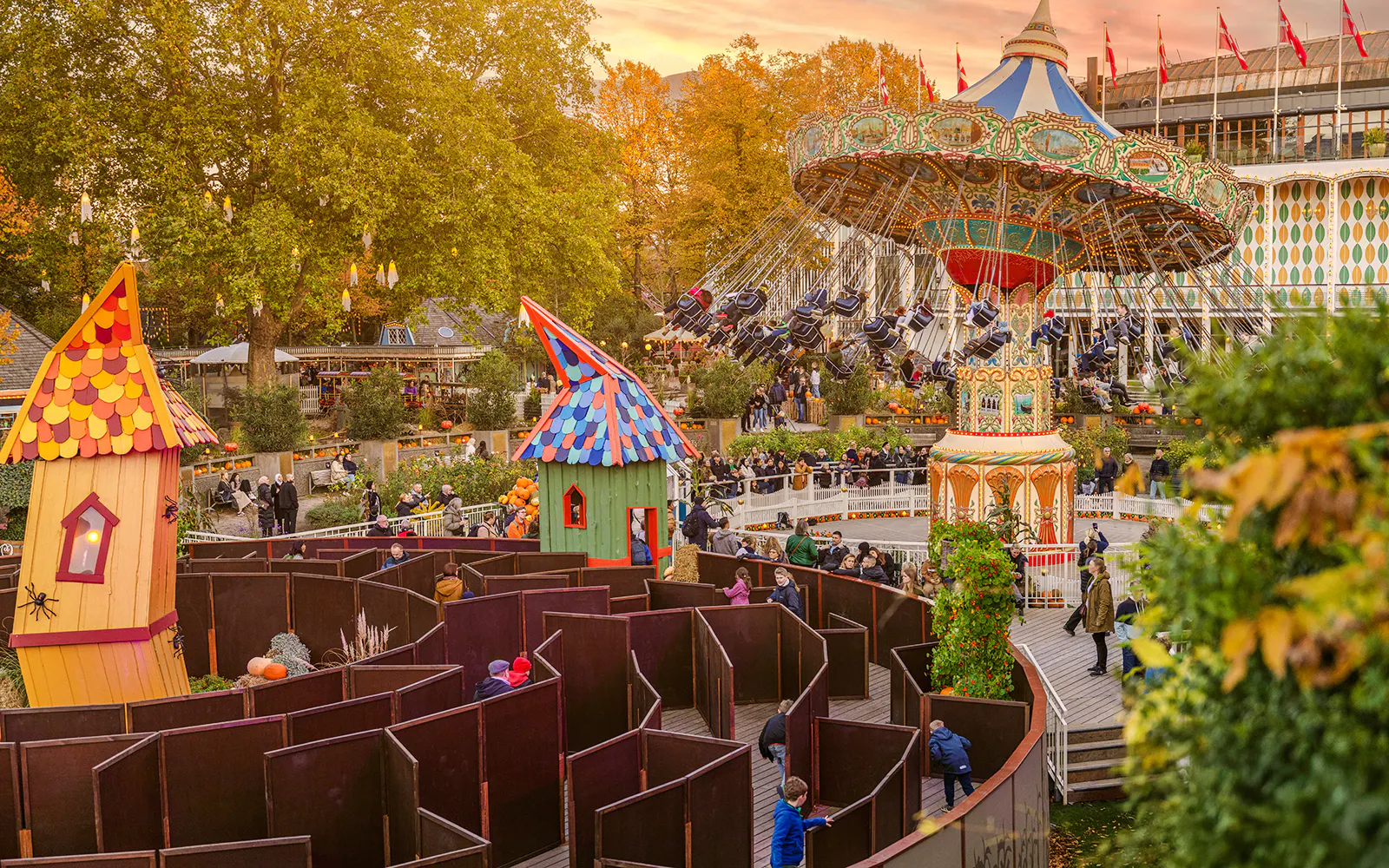 Guests enjoying Halloween rides and a maze at Tivoli Gardens, Copenhagen.