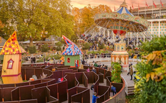 Guests enjoying Halloween rides and a maze at Tivoli Gardens, Copenhagen.