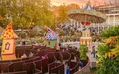 Guests enjoying Halloween rides and a maze at Tivoli Gardens, Copenhagen.