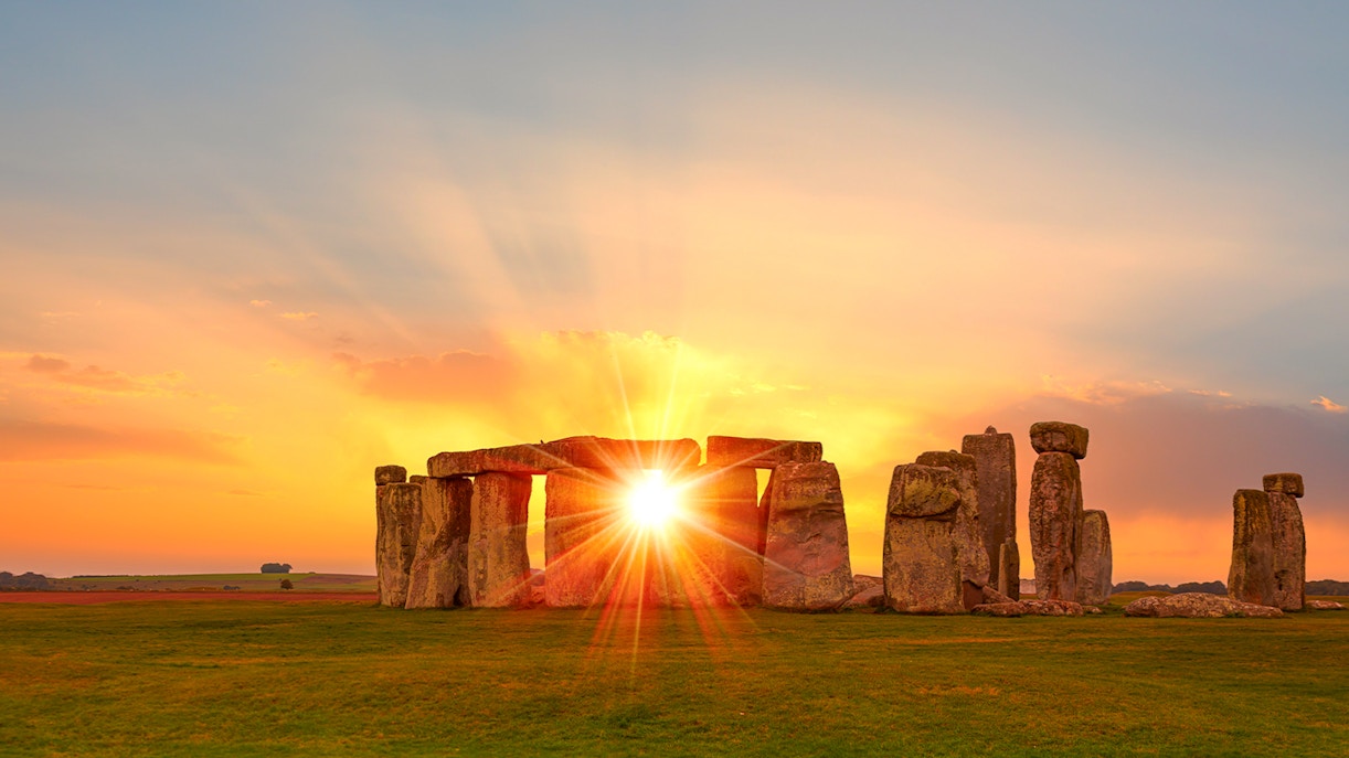 Stonehenge at sunset with sun rays through the stones, Wiltshire, England.