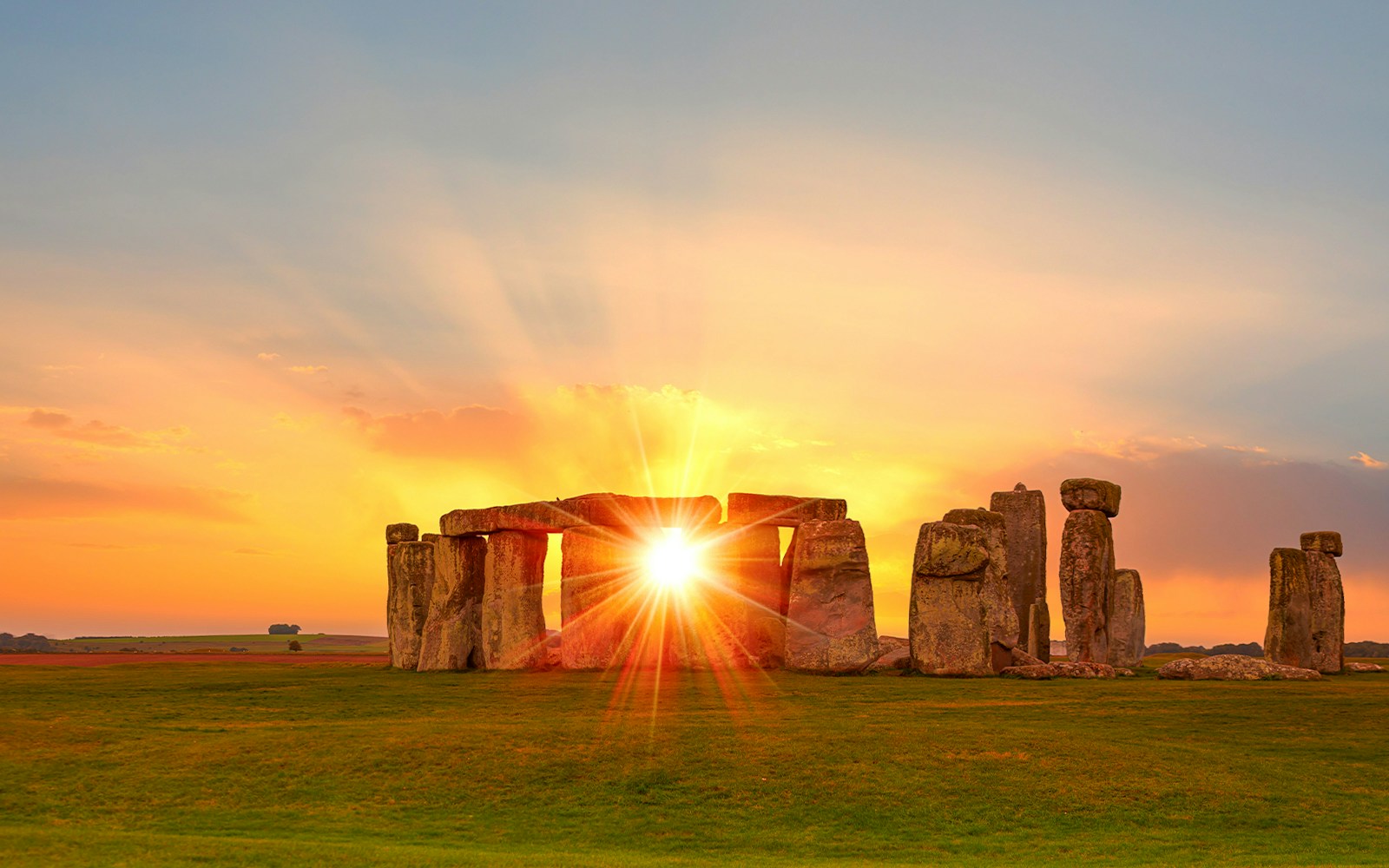 Stonehenge at sunset with sun rays through the stones, Wiltshire, England.