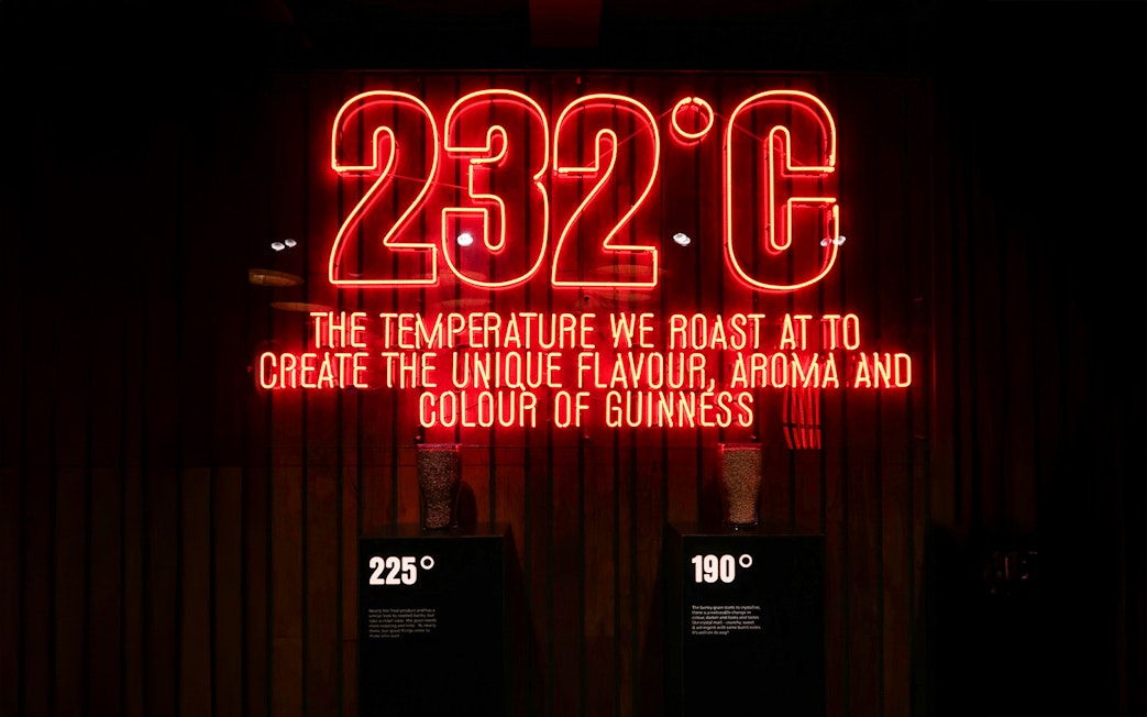 Neon sign at Guinness Storehouse showing roasting temperature for flavor creation.