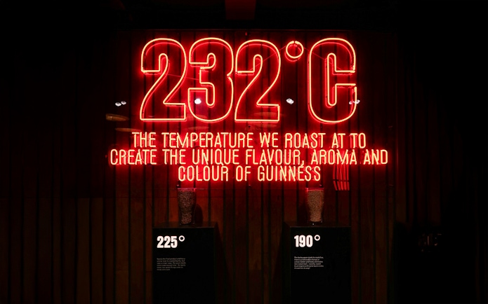 Neon sign at Guinness Storehouse showing roasting temperature for flavor creation.