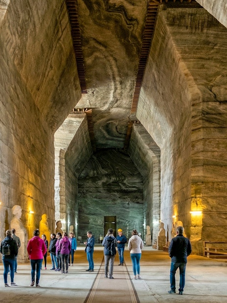 Guests exploring the vast chambers of Slanic Salt Mine in Romania.