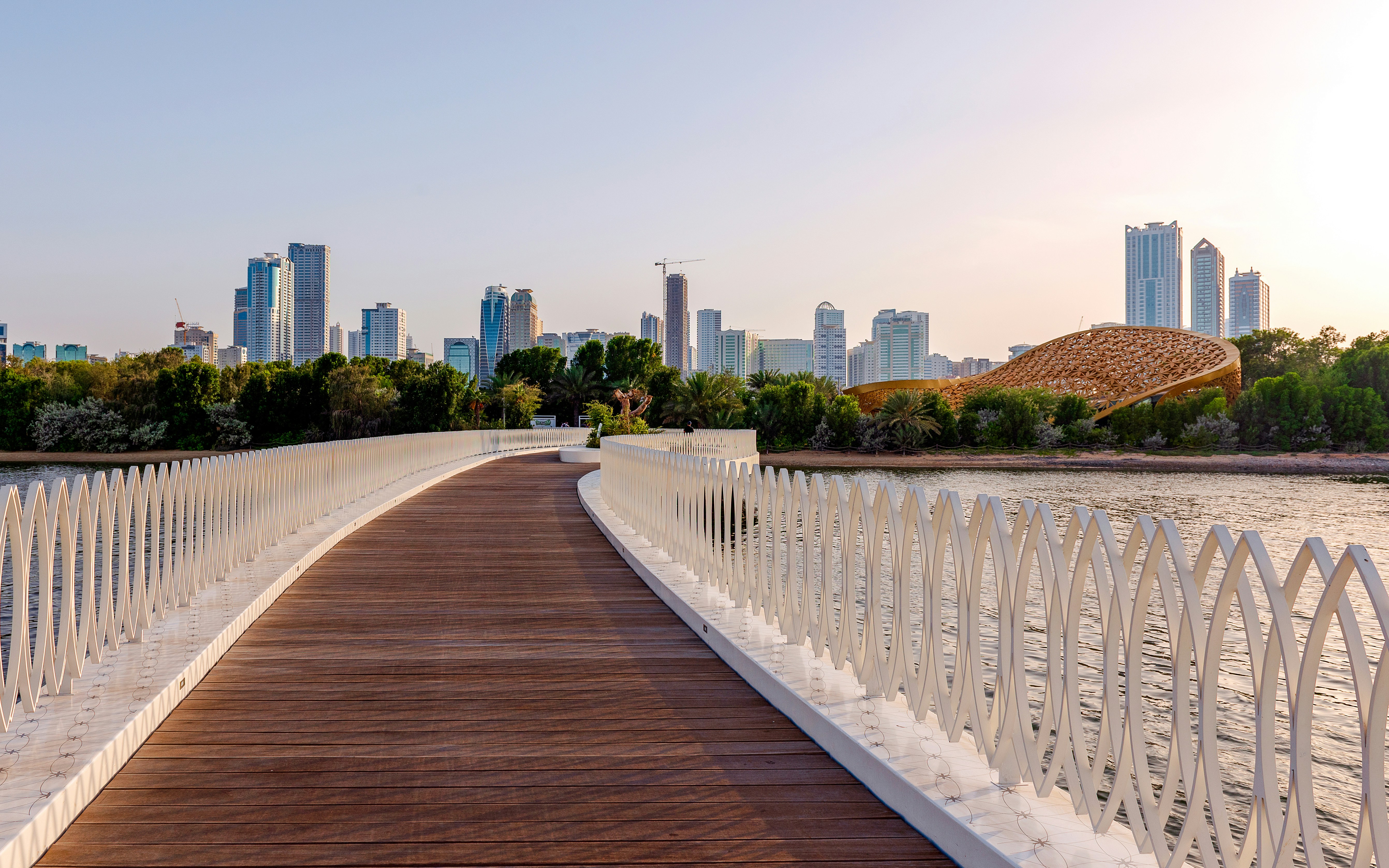 Bridge leading to Al Noor Island, Sharjah with city skyline in the background.