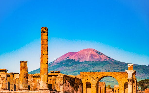 Pompeii ruins with Mount Vesuvius in the background, Naples City Pass tour.