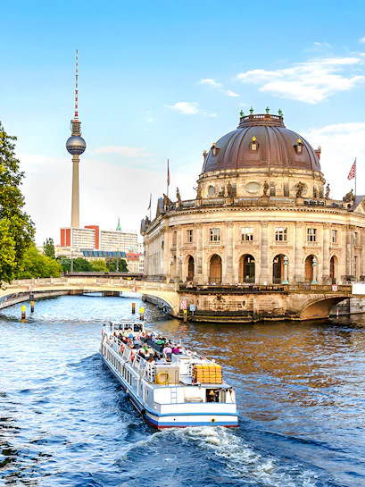 Berlin City Cruise passing Bode-Museum with TV Tower in background.