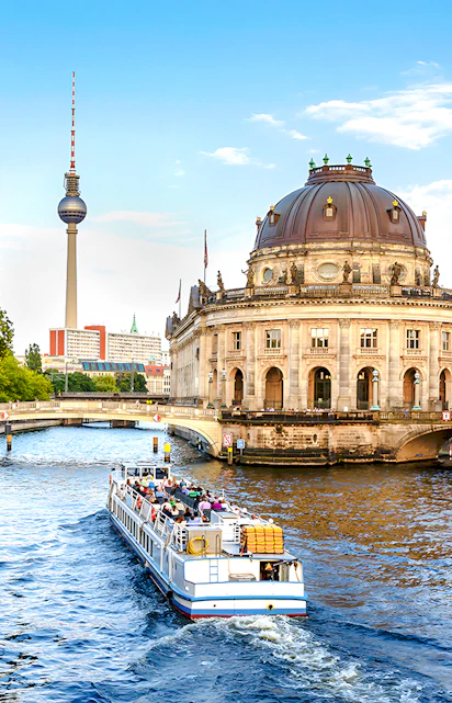 Berlin City Cruise passing Bode-Museum with TV Tower in background.