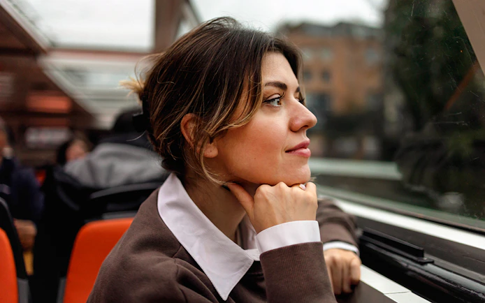 Woman enjoying view on Amsterdam canal cruise.