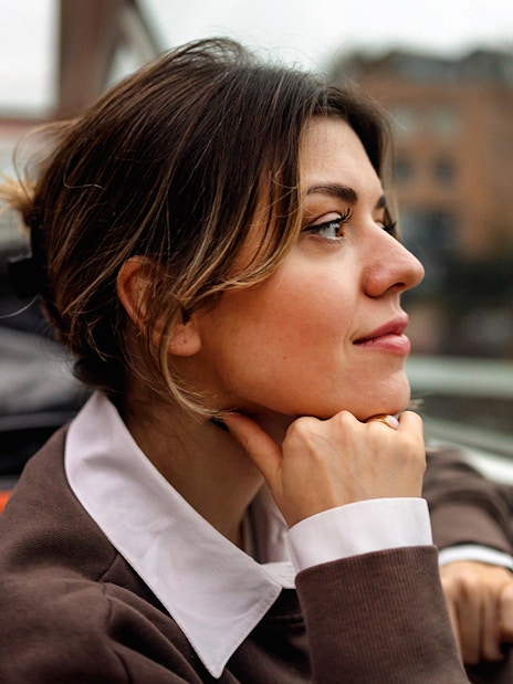 Woman enjoying view on Amsterdam canal cruise.