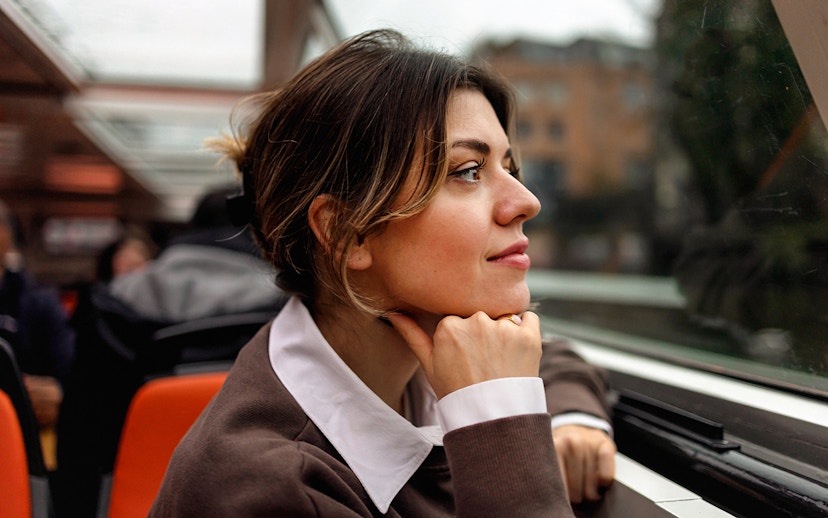 Woman enjoying view on Amsterdam canal cruise.