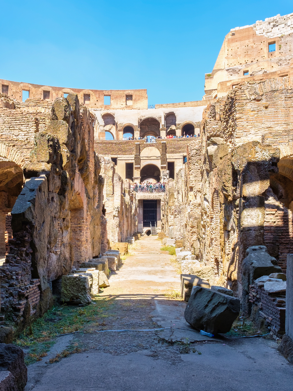 Underground level of the Colosseum in Rome showing ancient stone walls and pathways.
