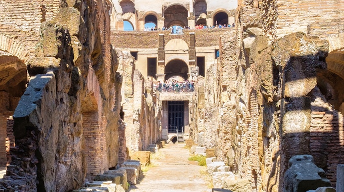 Underground level of the Colosseum in Rome showing ancient stone walls and pathways.