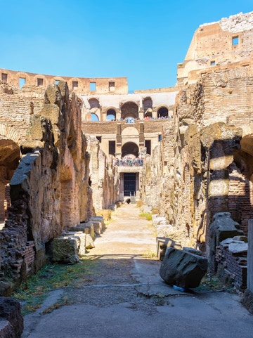 Underground level of the Colosseum in Rome showing ancient stone walls and pathways.