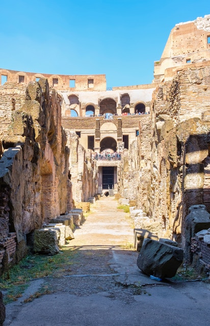 Underground level of the Colosseum in Rome showing ancient stone walls and pathways.