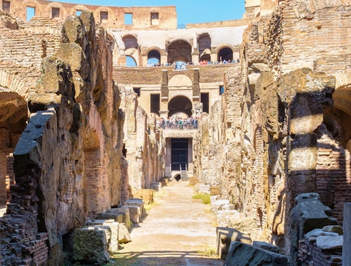Underground level of the Colosseum in Rome showing ancient stone walls and pathways.