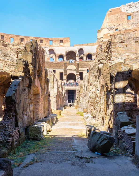 Underground level of the Colosseum in Rome showing ancient stone walls and pathways.