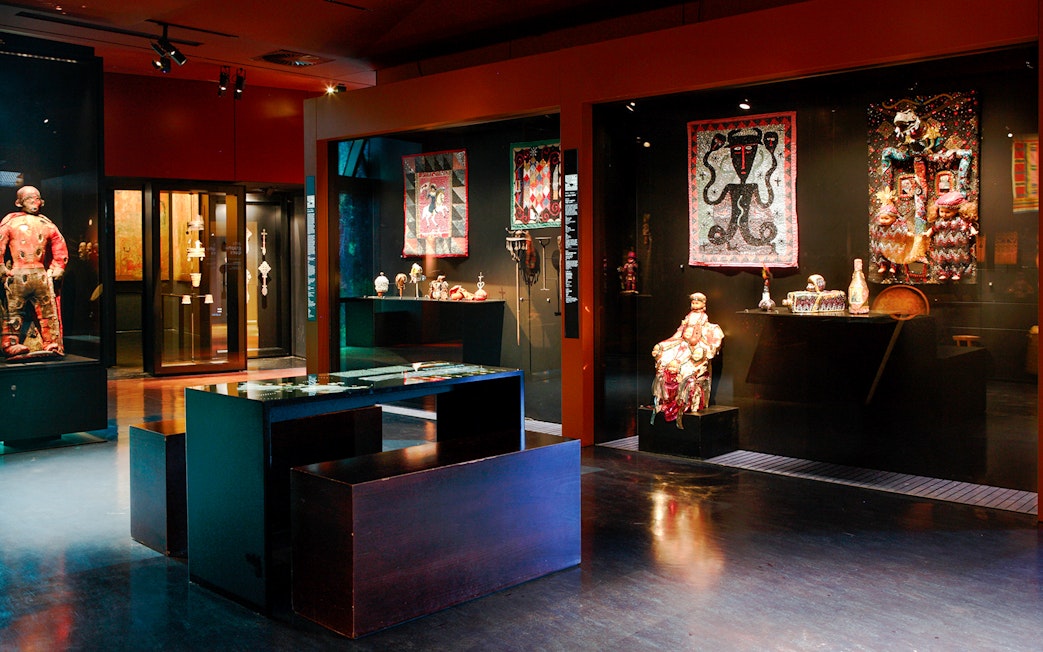 Exhibit of cultural artifacts and textiles at Musée du Quai Branly, Paris.