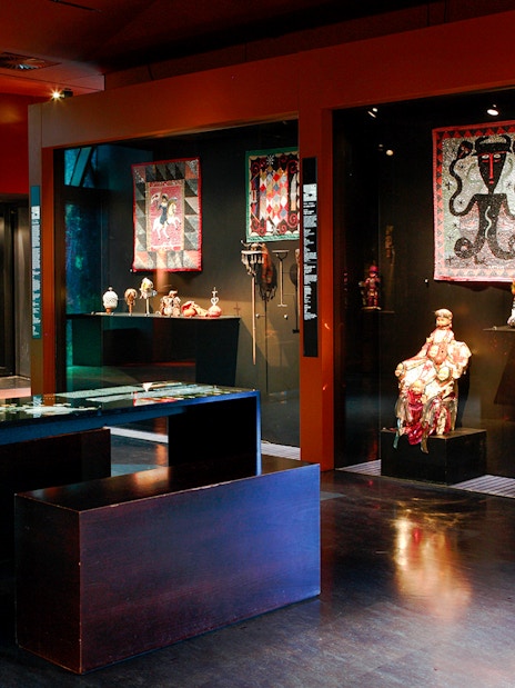 Exhibit of cultural artifacts and textiles at Musée du Quai Branly, Paris.