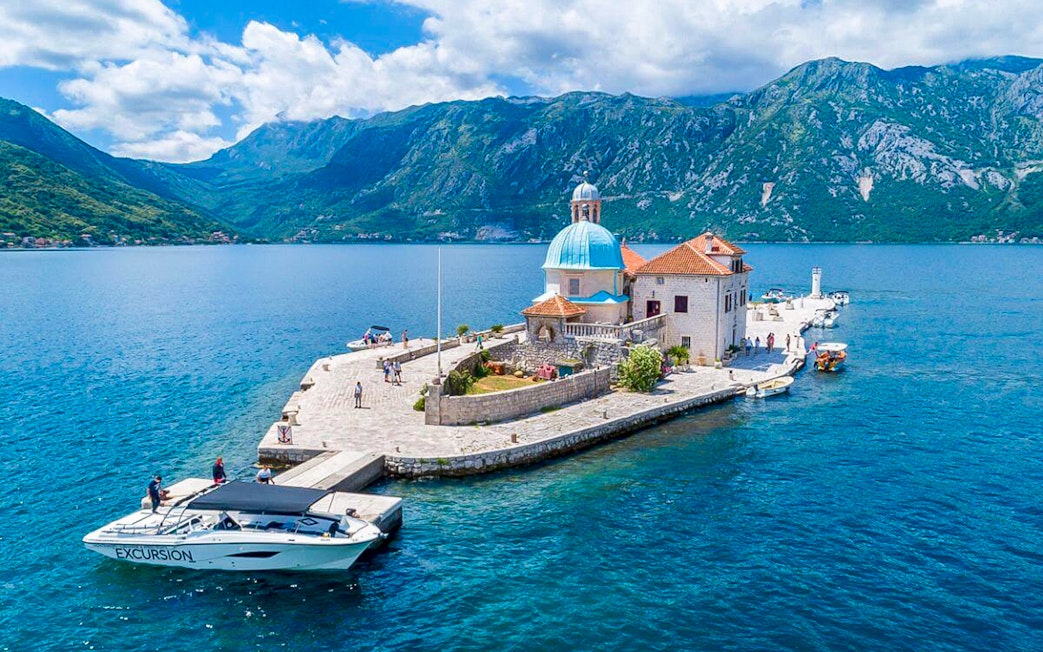 Our Lady of the Rocks Island with church and tourists in Kotor Bay, Montenegro.