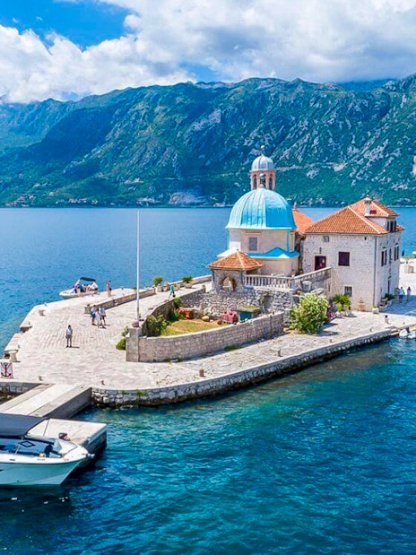 Our Lady of the Rocks Island with church and tourists in Kotor Bay, Montenegro.