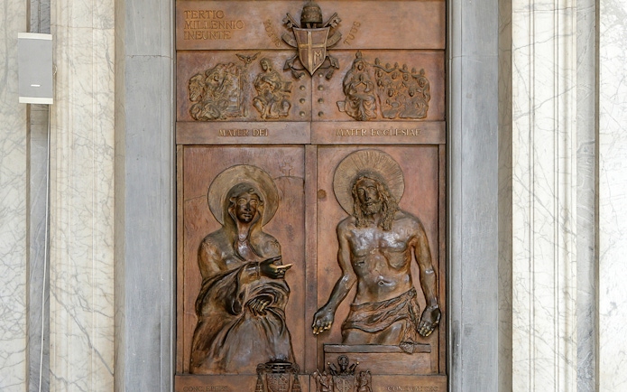 Close-up of Holy Gates relief in Basilica of Santa Maria Maggiore, Rome, depicting religious figures.
