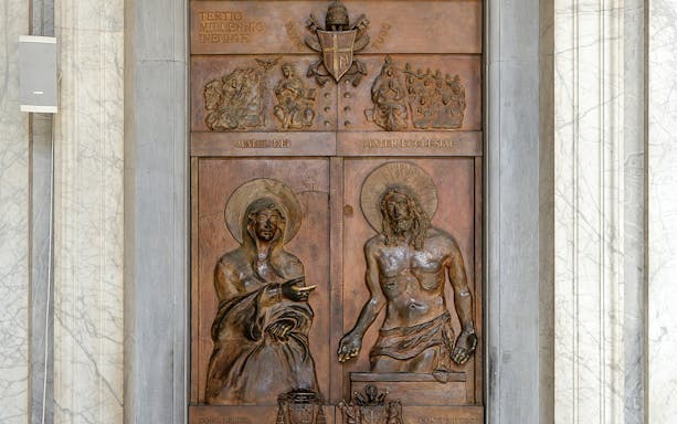 Close-up of Holy Gates relief in Basilica of Santa Maria Maggiore, Rome, depicting religious figures.