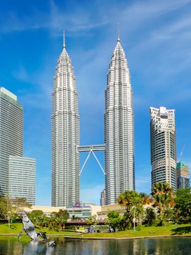 Petronas Twin Towers in Kuala Lumpur, Malaysia, with surrounding park and skyline.