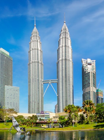 Petronas Twin Towers in Kuala Lumpur, Malaysia, with surrounding park and skyline.