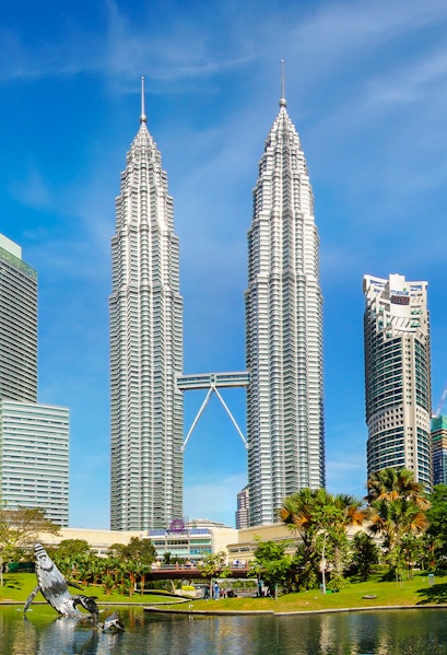 Petronas Twin Towers in Kuala Lumpur, Malaysia, with surrounding park and skyline.