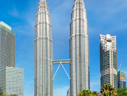 Petronas Twin Towers in Kuala Lumpur, Malaysia, with surrounding park and skyline.