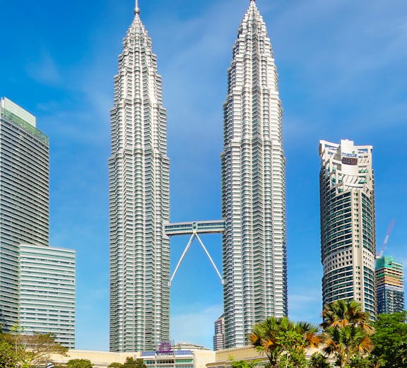 Petronas Twin Towers in Kuala Lumpur, Malaysia, with surrounding park and skyline.