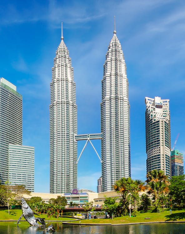 Petronas Twin Towers in Kuala Lumpur, Malaysia, with surrounding park and skyline.