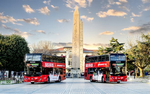 Hop-on hop-off buses near the Obelisk of Theodosius in Istanbul.
