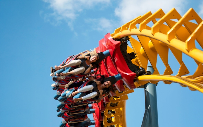 Riders on Isla Mágica roller coaster in Seville, Spain, during a loop.