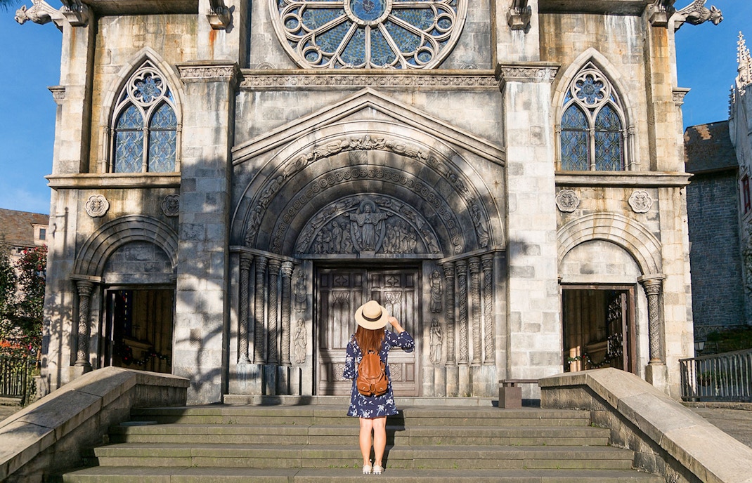Tourist exploring French village architecture on Bana Hills, Danang, Vietnam.
