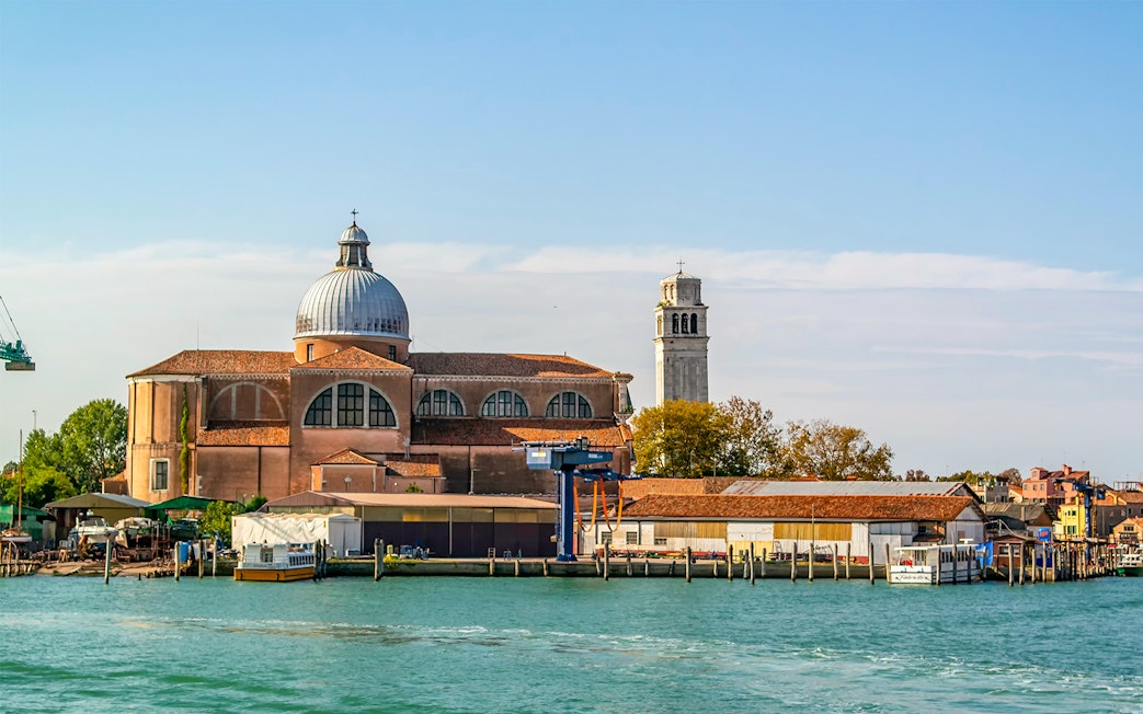 Basilica of San Pietro di Castello with bell tower, Venice waterfront.