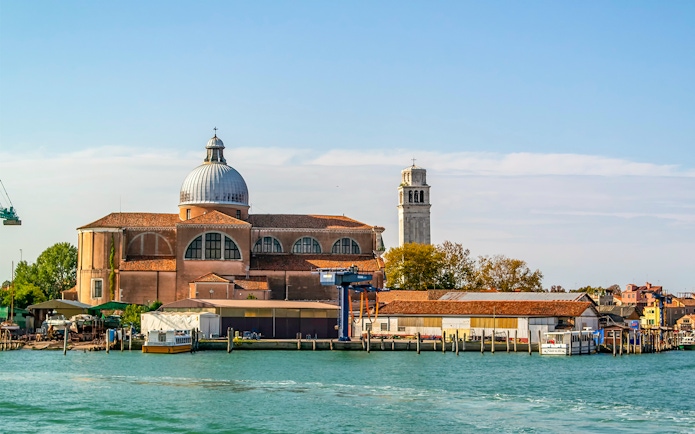 Basilica of San Pietro di Castello with bell tower, Venice waterfront.