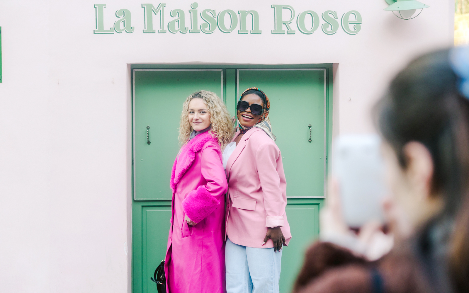 Ladies posing at La Maison Rose during Montmartre Walking Tour in Paris.