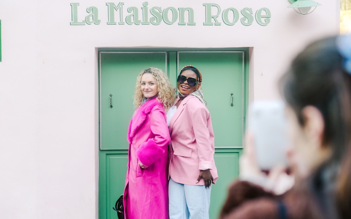 Ladies posing at La Maison Rose during Montmartre Walking Tour in Paris.