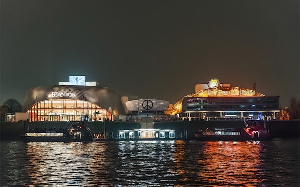 Grand Harbor evening view with illuminated theaters reflecting on the water.