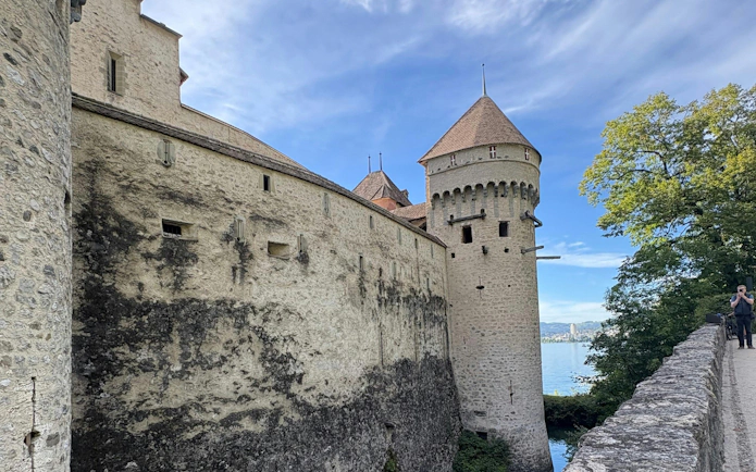 Chillon Castle stone walls and tower by Lake Geneva, Switzerland.