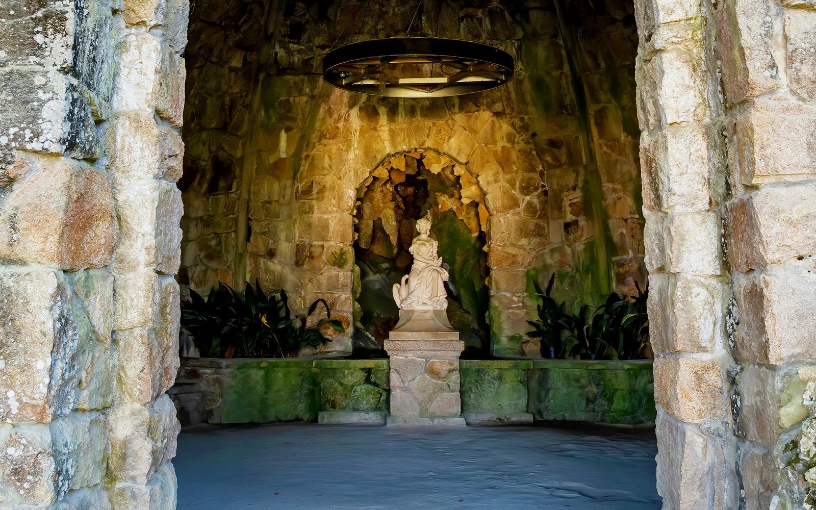 Quinta da Regaleira Leda's Cave entrance with intricate stone carvings, Sintra, Portugal.